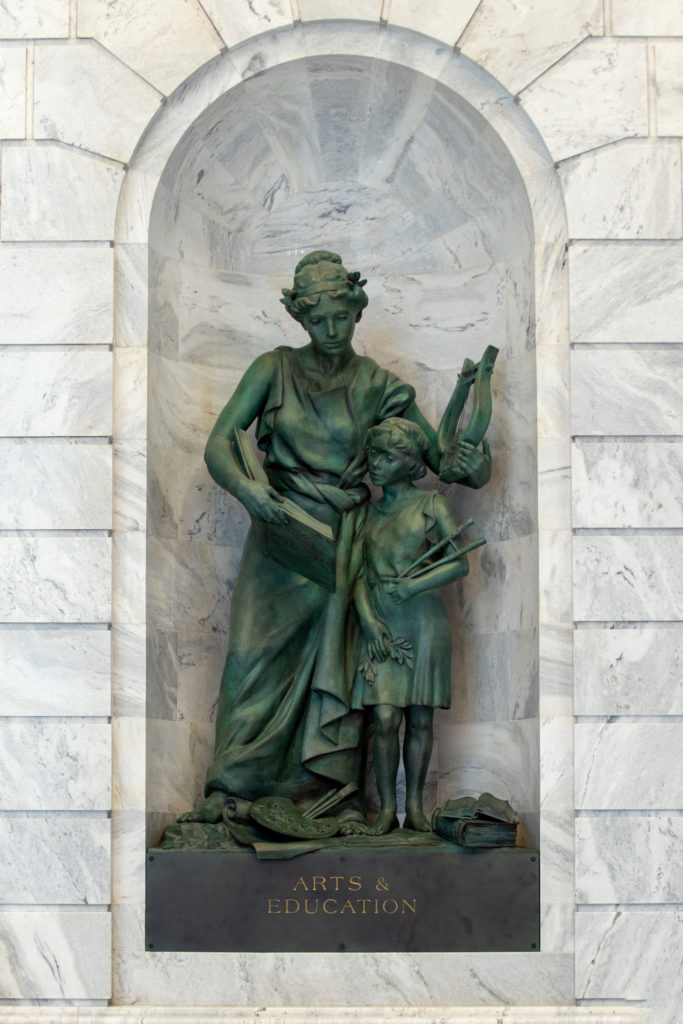 Arts and Education bronze sculpture in marble niche.