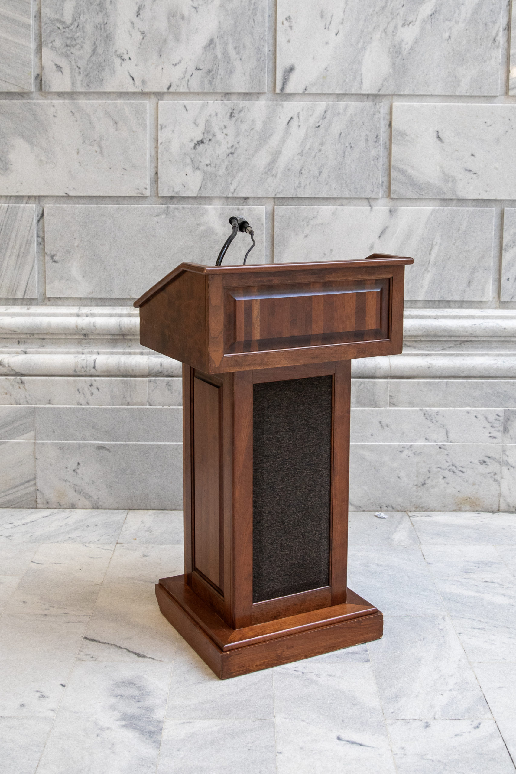 Wood podium on marble backdrop