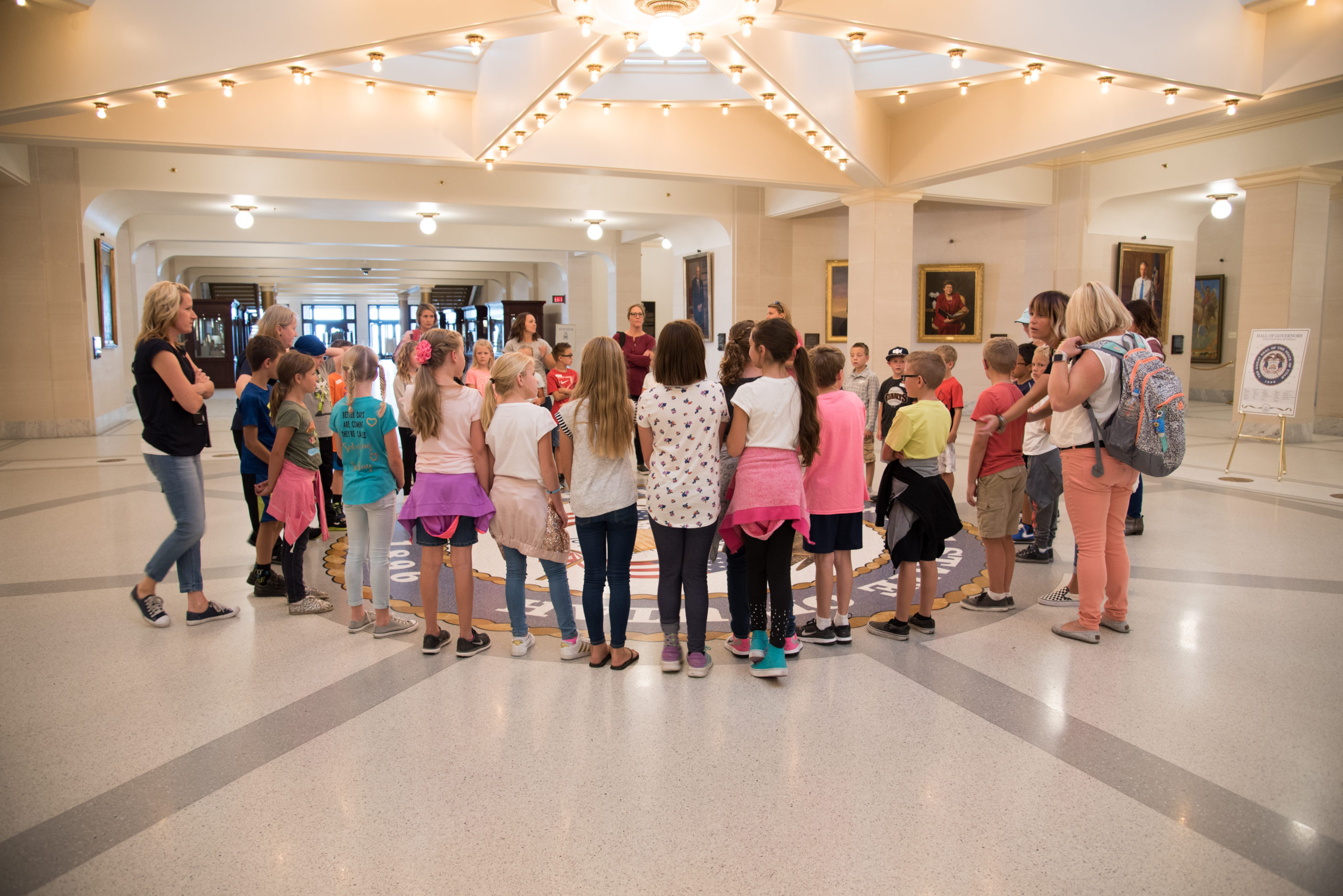 School age children on a guided tour in the Hall of Governors at the Utah State Capitol.