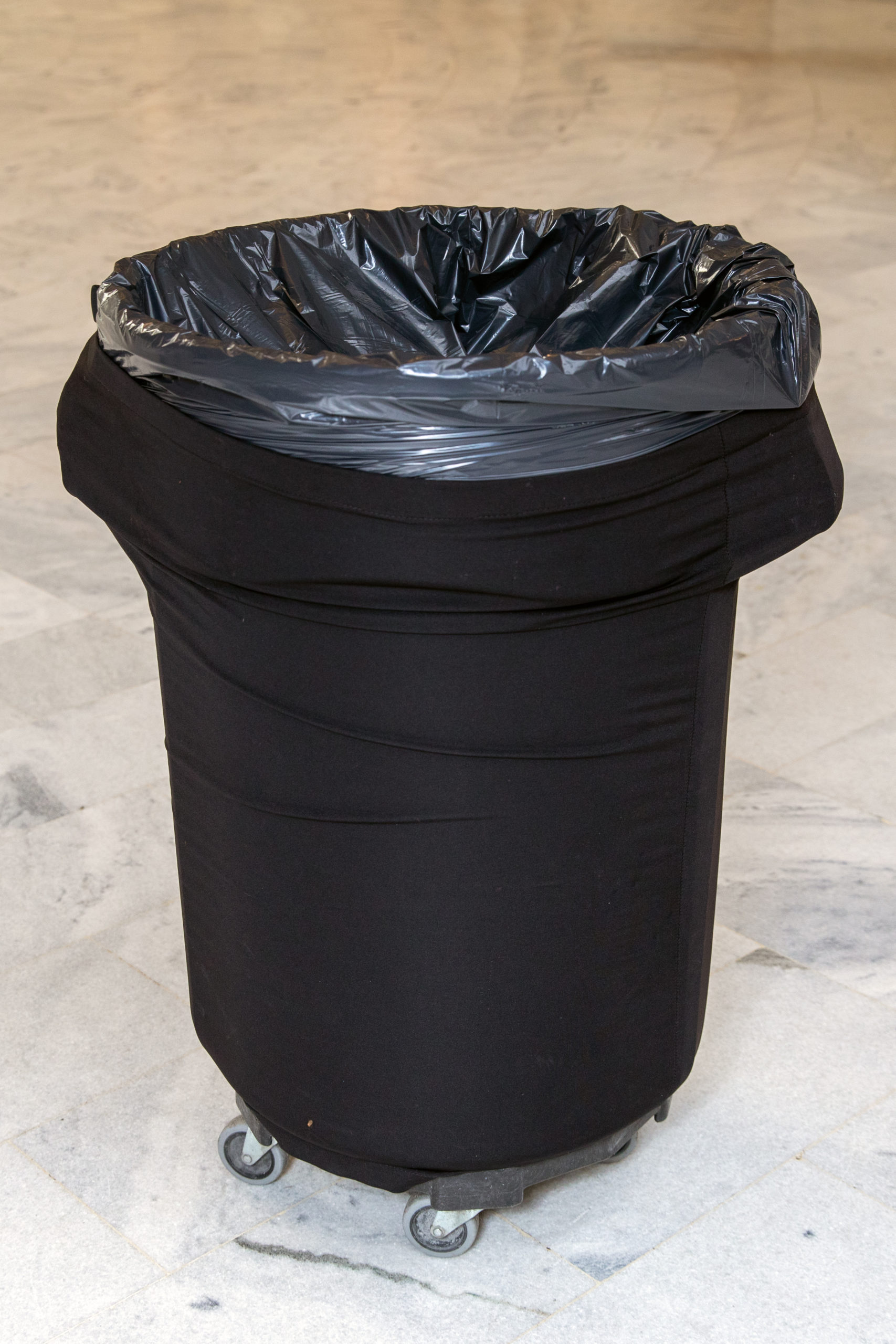 Black garbage can.